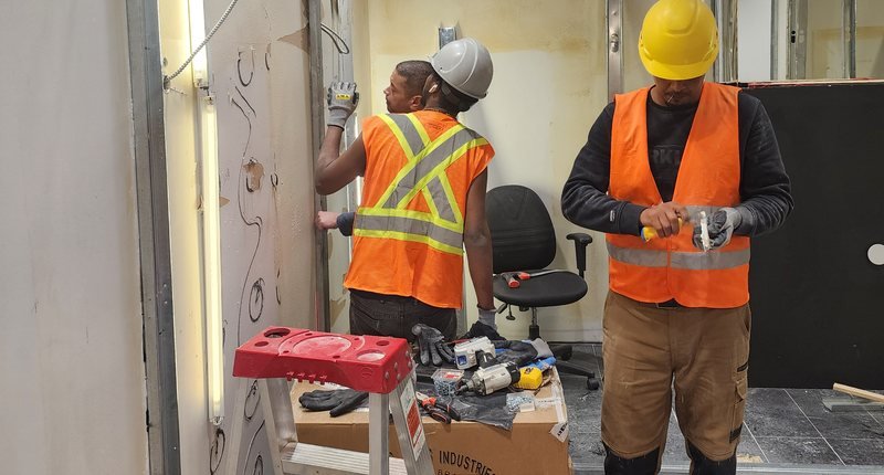 AtlantCare crew installing wall track and finishes during a commercial fit-out