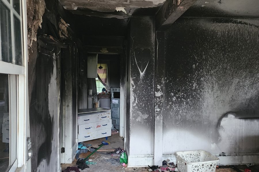 Fire and smoke damage to a ceiling and walls after a residential fire