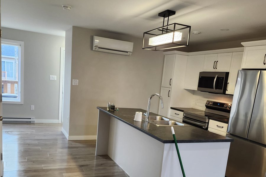 Freshly cleaned kitchen and open-plan living area in a new unit
