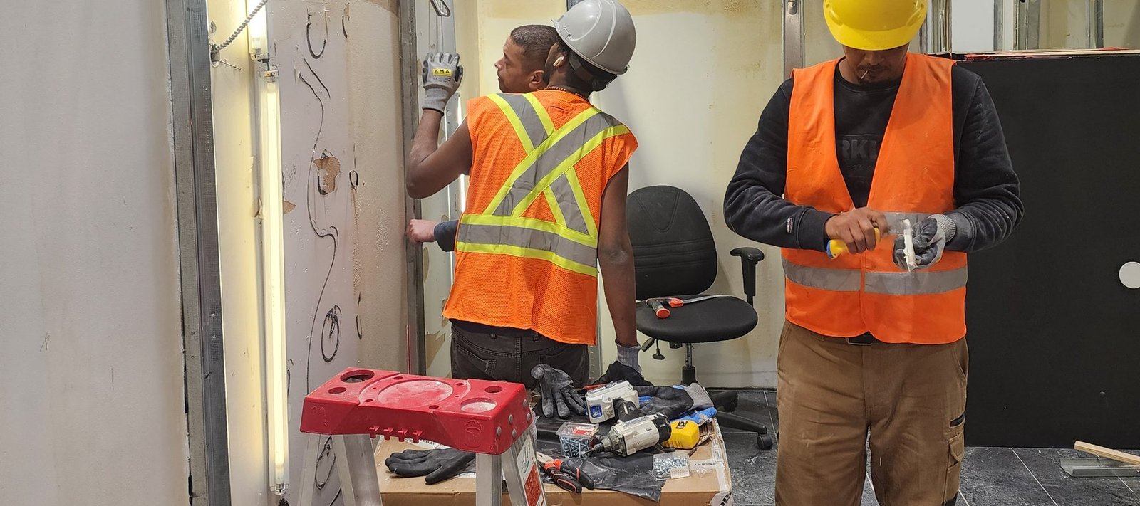 AtlantCare crew installing wall track and finishes during a commercial fit-out
